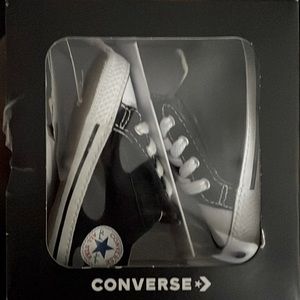 Black and white baby’s Converse size 3 crib